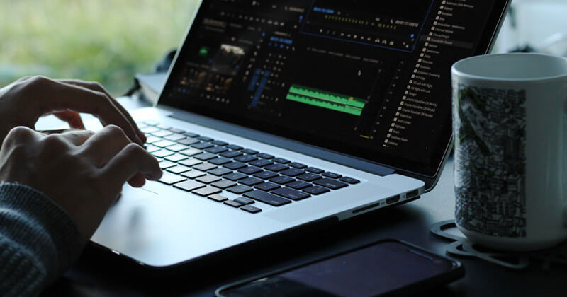 How-to-determine-audio-file-size-waveform A video editor works on an audio waveform in Adobe Premiere Pro