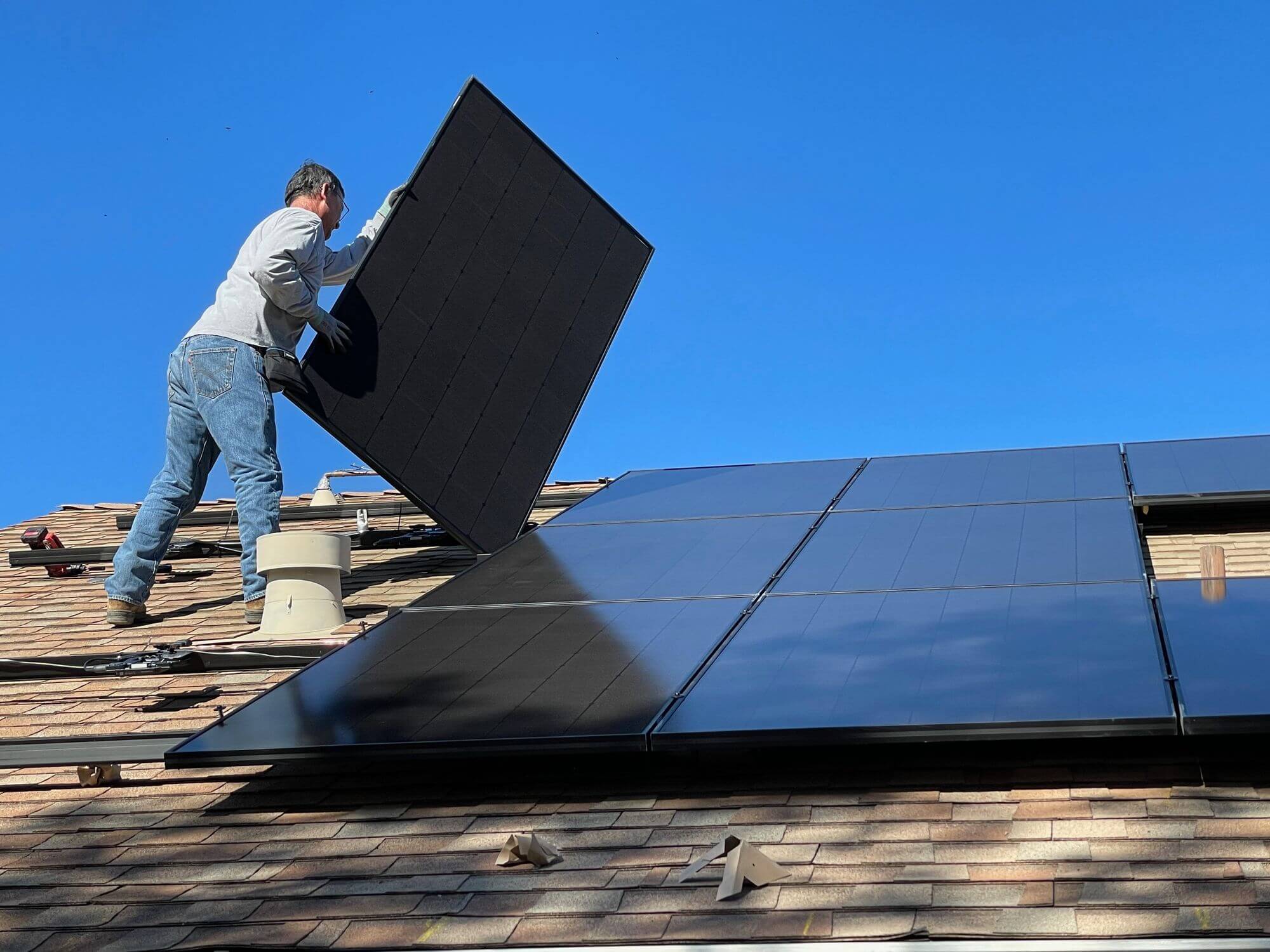 Solar-panels A man installs solar panels