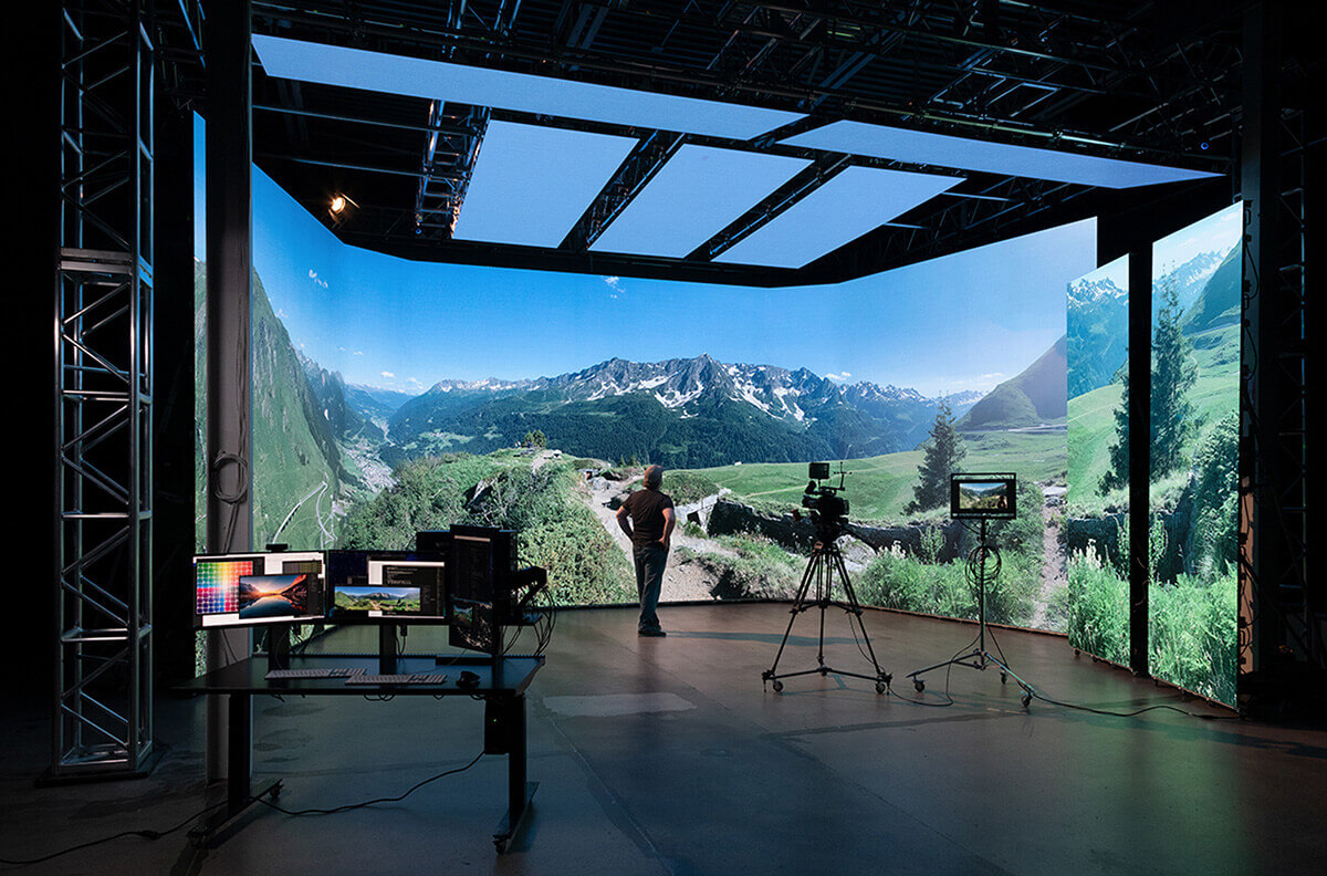 virtual-production-stage a man stands inside of a virtual production stage