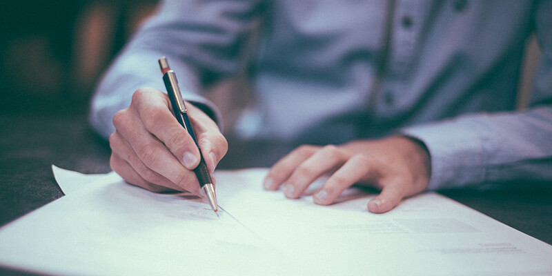 working-with-clients-invoicing A man fills out an invoice for a client